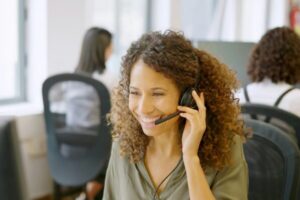 Telephone operator answering with a smile in a coworking space