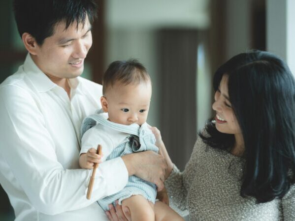 young Asian family are happy together at home by life insurance concept, child baby and mother